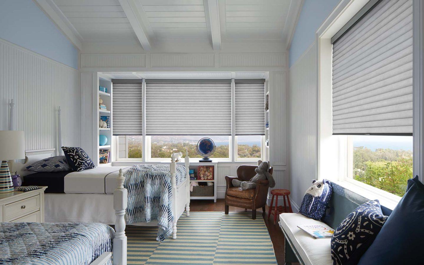 a bedroom with Hunter Douglas cellular honeycomb sonette blinds