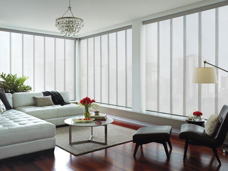 a living room with Hunter Douglas vertical skyline blinds