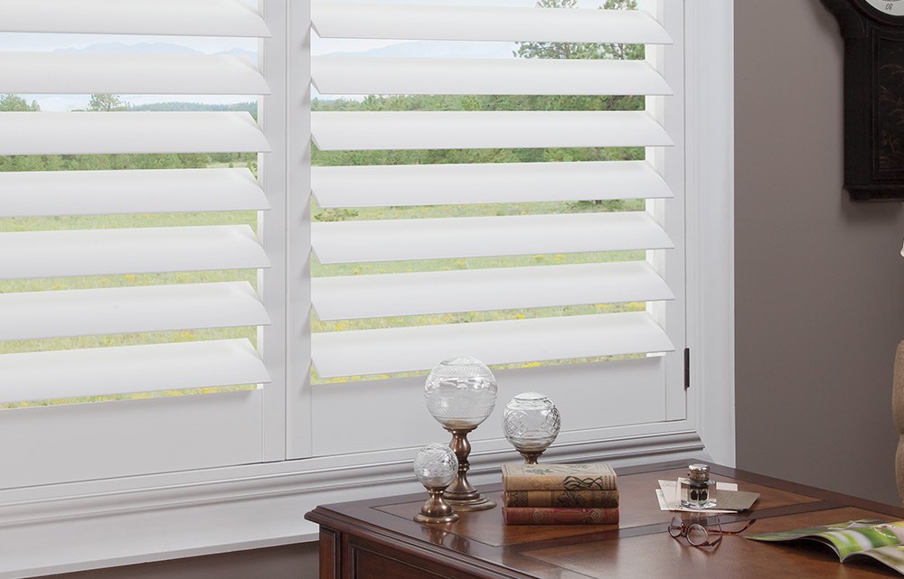 white Hunter Douglas new style hybrid shutters in a home office