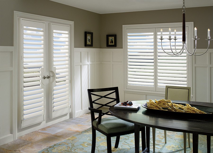 a dining room with Hunter Douglas french door shutters