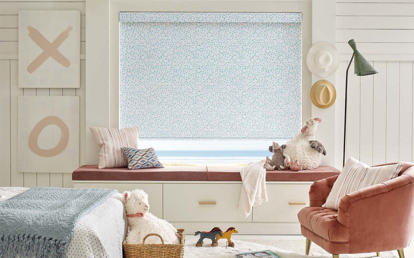 a child's bedroom with Hunter Douglas roller shade blinds covering the window