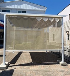 a patio cover outside of the Sunshade Blinds and Drapery storefront in Ajax